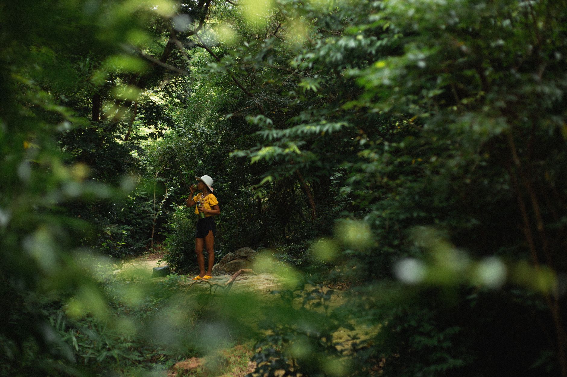 hiker drinking water trail