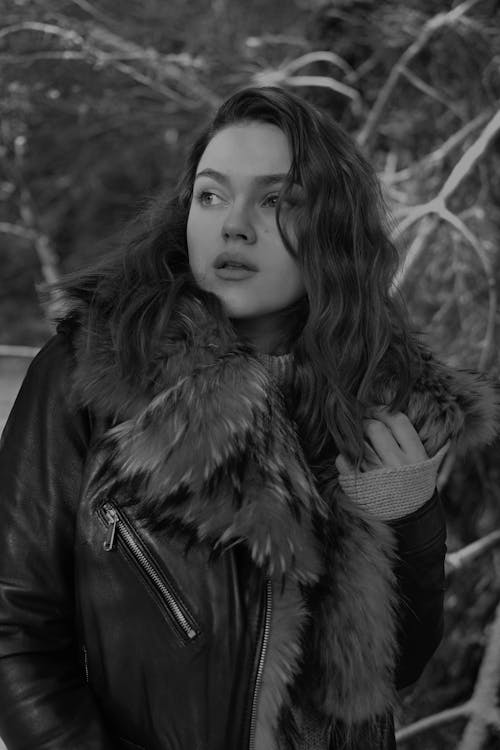 A Grayscale of a Woman Wearing a  Furry Leather Jacket