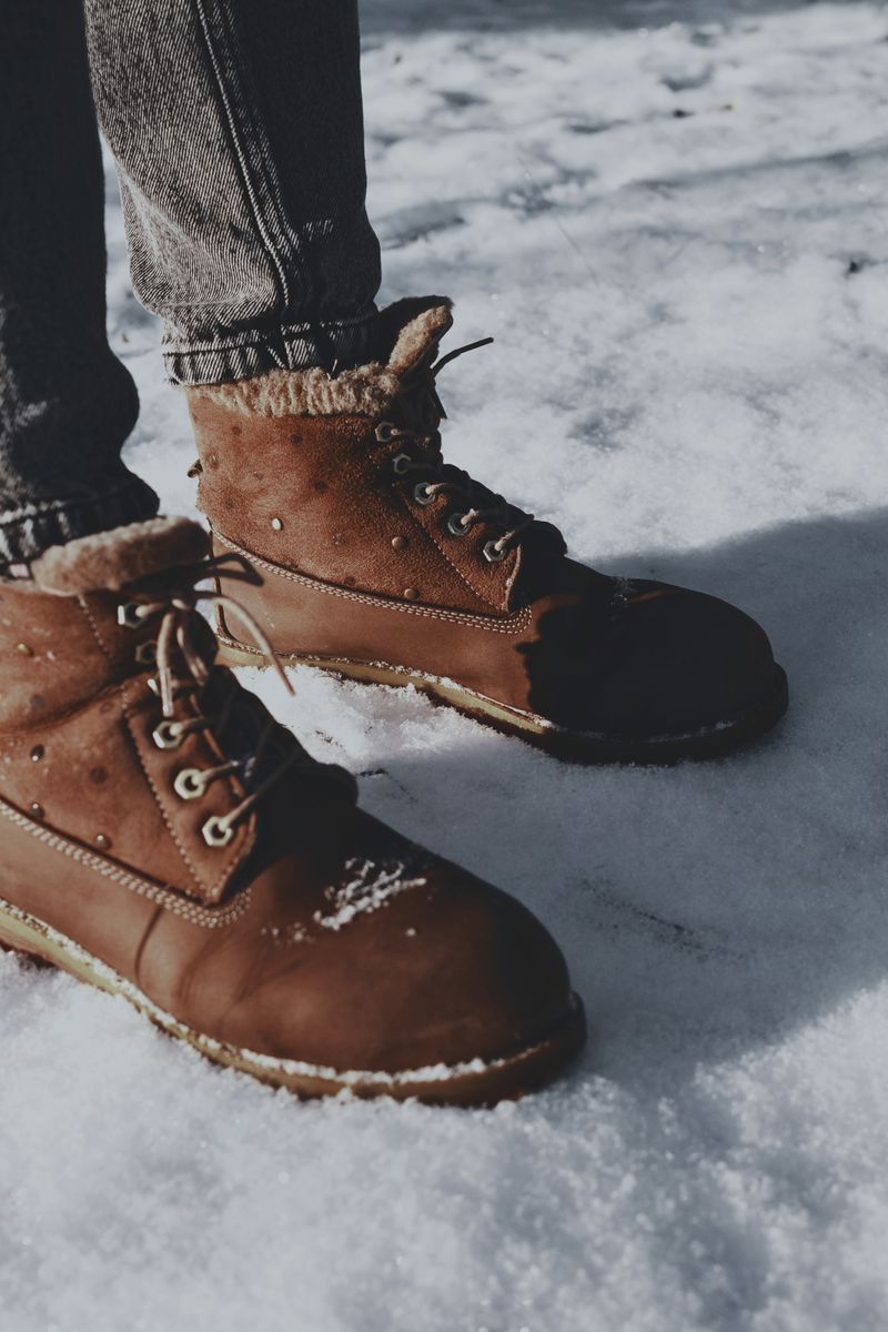 Brown boots on snow-covered ground