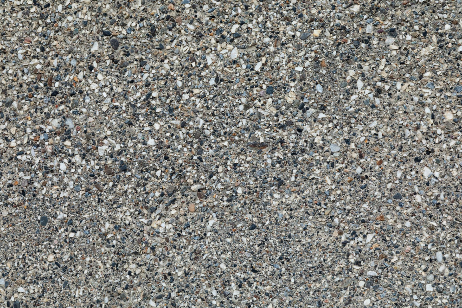 High-resolution image of rough gray concrete texture with detailed pebble inclusions.