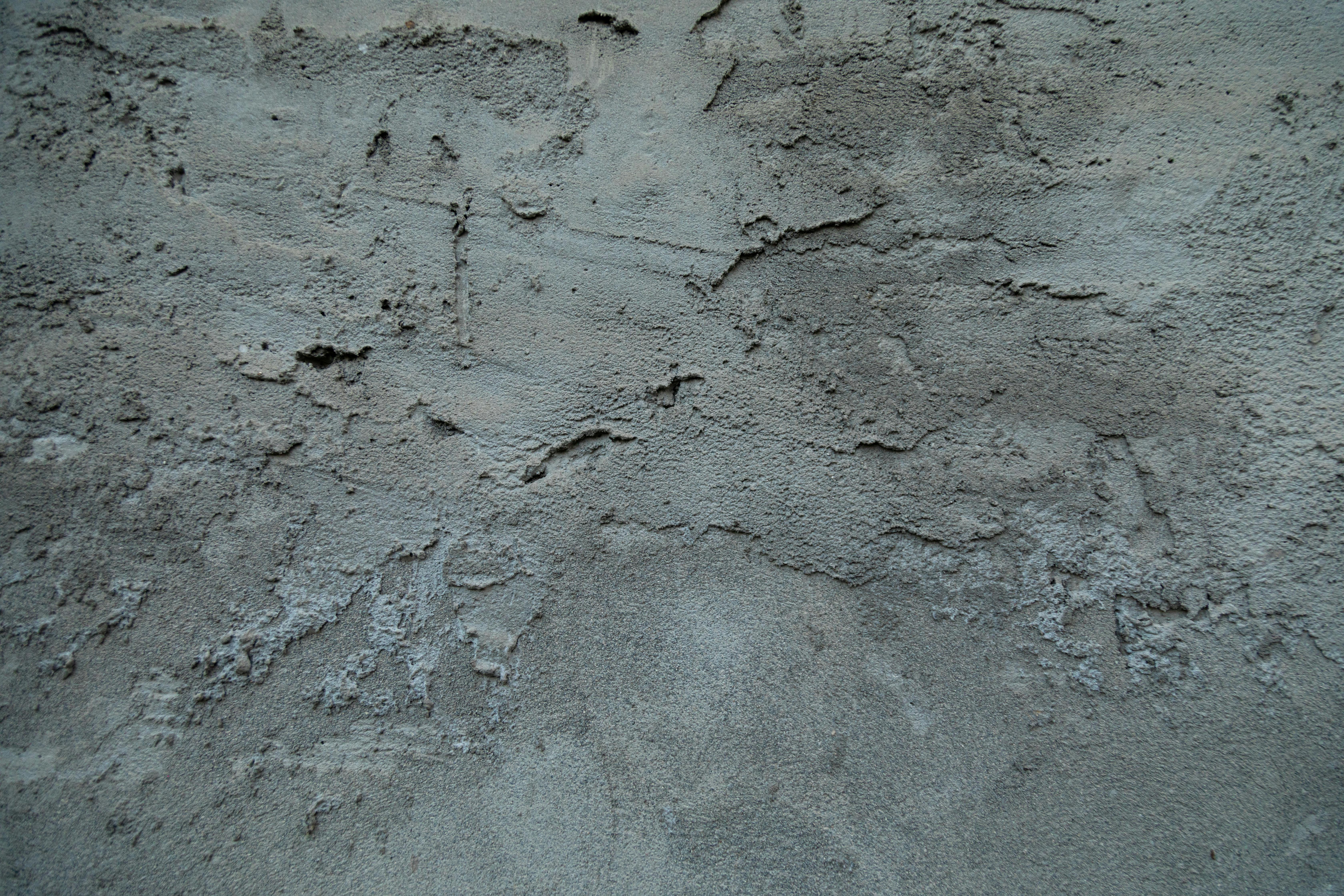 Inspection of uneven foundation slab showing cracks and measurement tools during a home foundation inspection in Garland