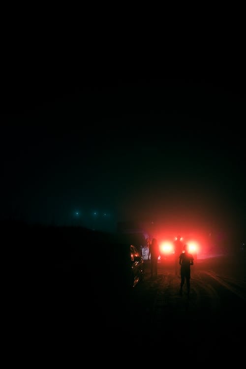 People walking down a foggy road 