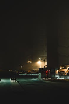 Mysterious nighttime view of an illuminated industrial hangar in Brownsville.