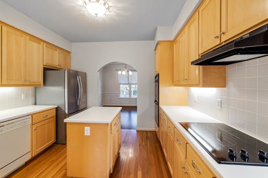 Spacious kitchen featuring wooden cabinets, a central island, and stainless steel appliances.