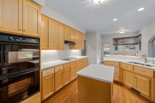 Black Kitchen Appliances on Brown Wooden Kitchen Cabinet