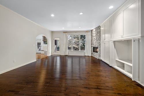 White Walls and Windows with Brown Wooden Flooring