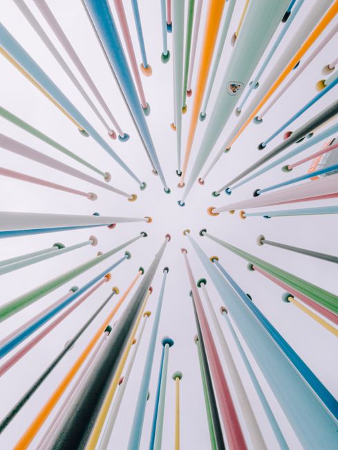 A vibrant array of vertical poles creates a fascinating diminishing perspective viewed from below.