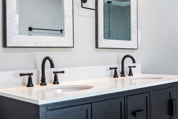 Bathroom vanity with double sink and framed mirrors