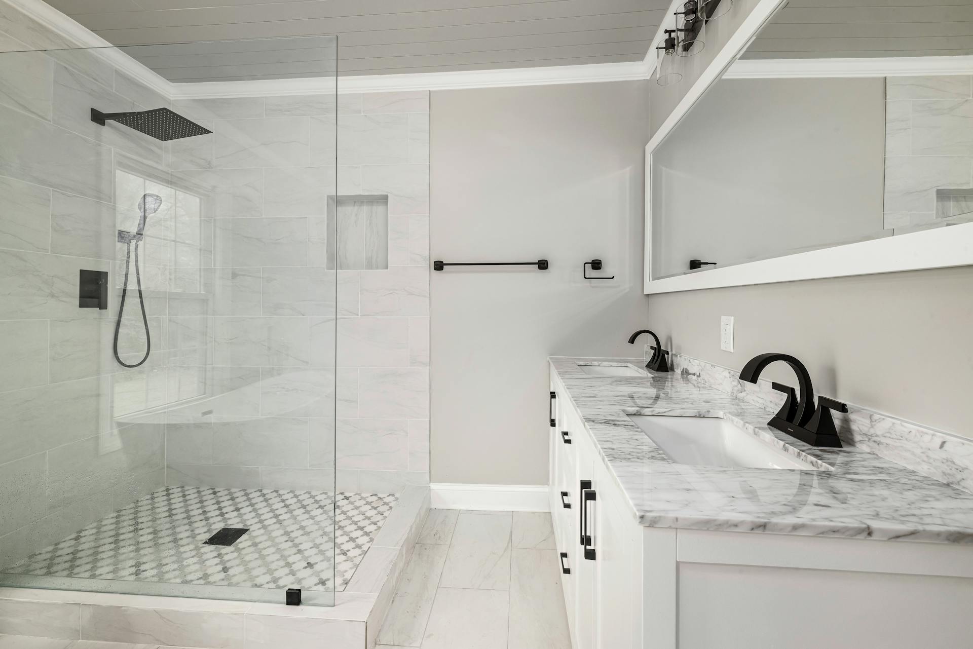 A Bathroom with Dual Sinks and a Shower Room