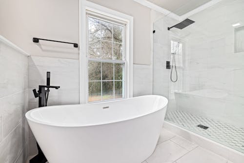 A Bath Tub beside a Shower Room