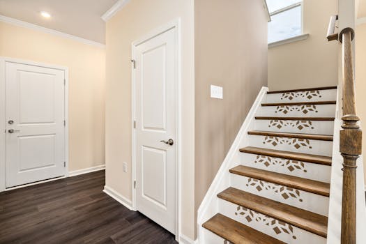 Spacious modern home interior featuring a creatively designed staircase with light colors.