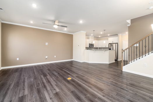 Bright modern interior with an open concept kitchen and empty living room.