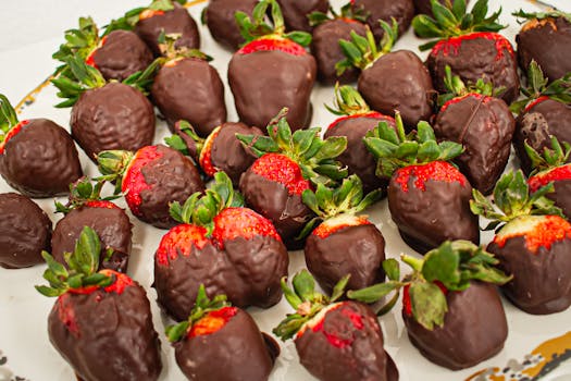 A mouth-watering display of fresh strawberries dipped in rich chocolate, offering a delightful sensory experience.