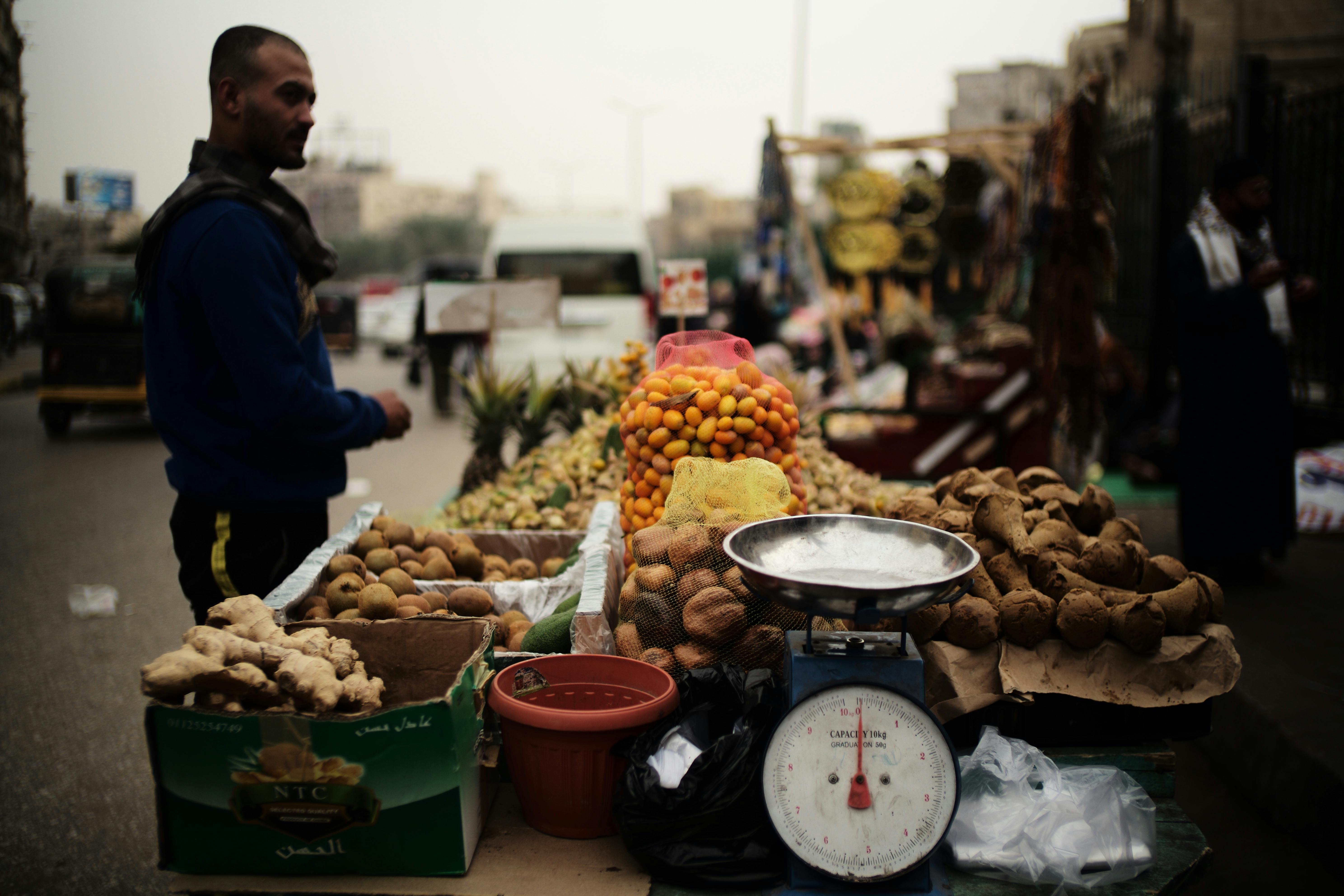 A bustling market stall in Cairo, Egypt, showcasing fresh produce and local trade in a vibrant street setting.