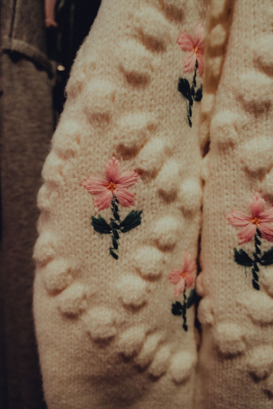 Pink blossoms on a knit cardigan