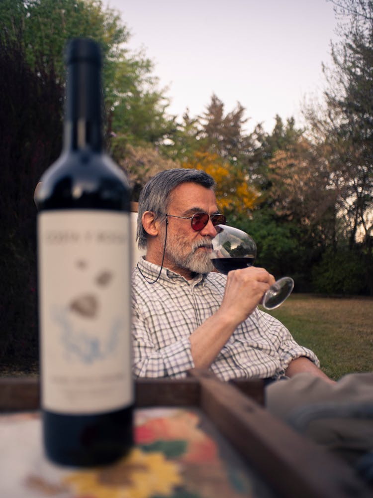 Photo Of An Elderly Man Drinking Wine