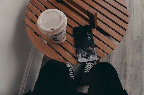 Free IPhone next to Cup of Coffee Stock Photo