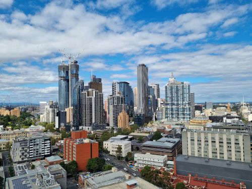 Free Panoramic view of Melbourne's urban skyline showcasing modern skyscrapers under a vibrant sky. Stock Photo