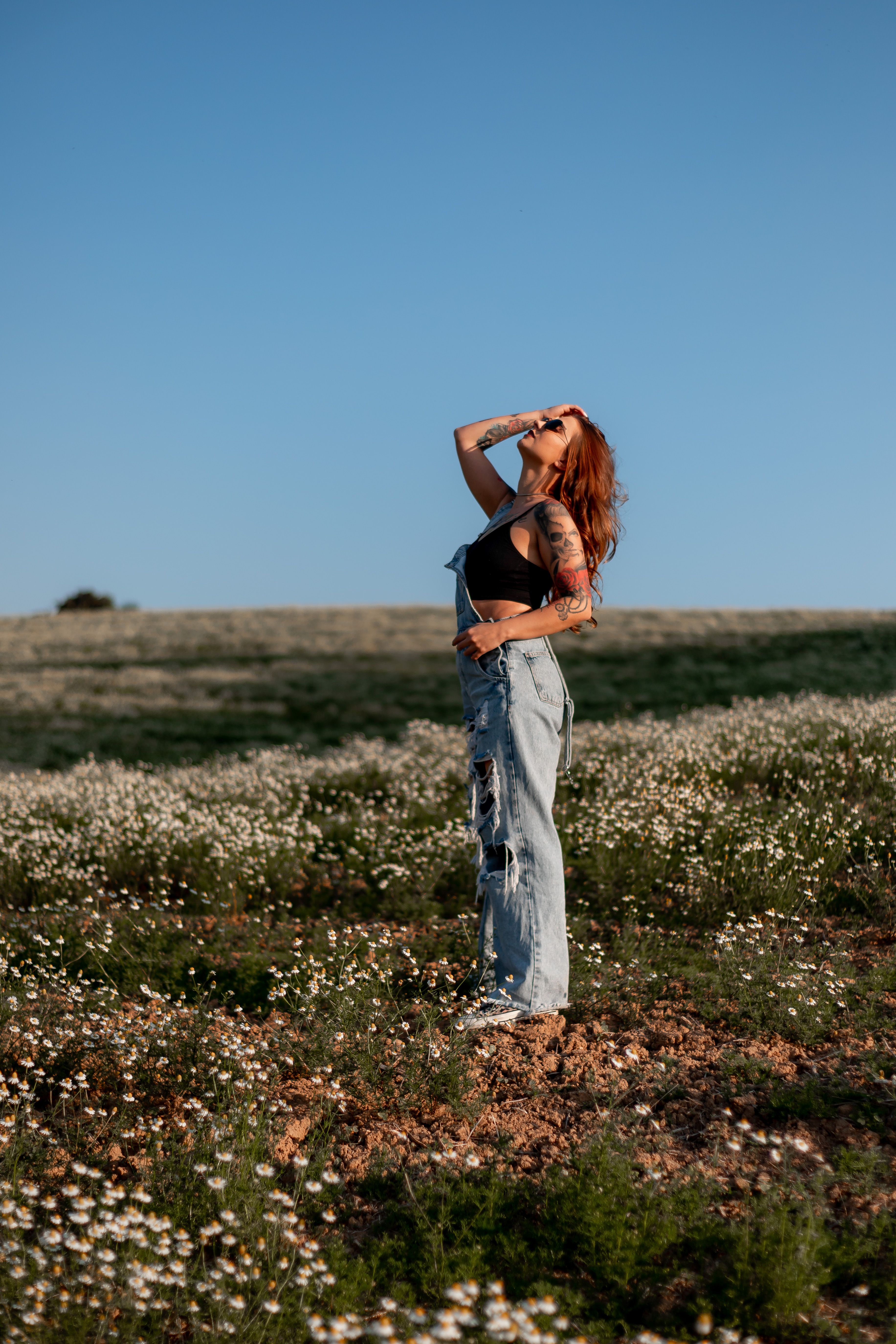 A Woman Standing in a Meadow · Free Stock Photo