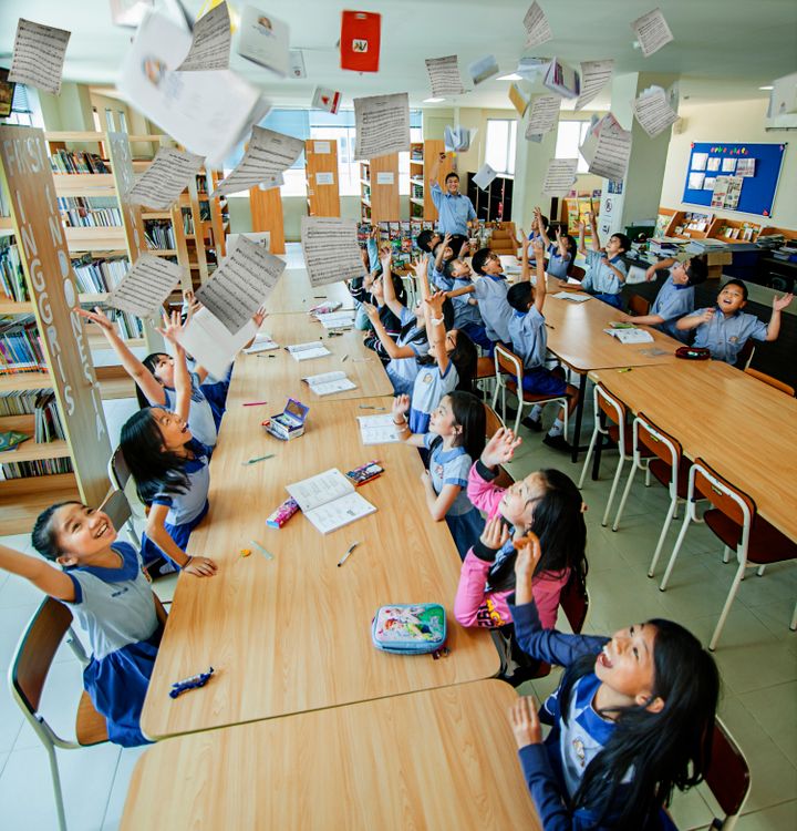 A Students Throwing Papers In Classroom Free Stock Photo A Students Throwing Papers In Classroom Free Stock Photo