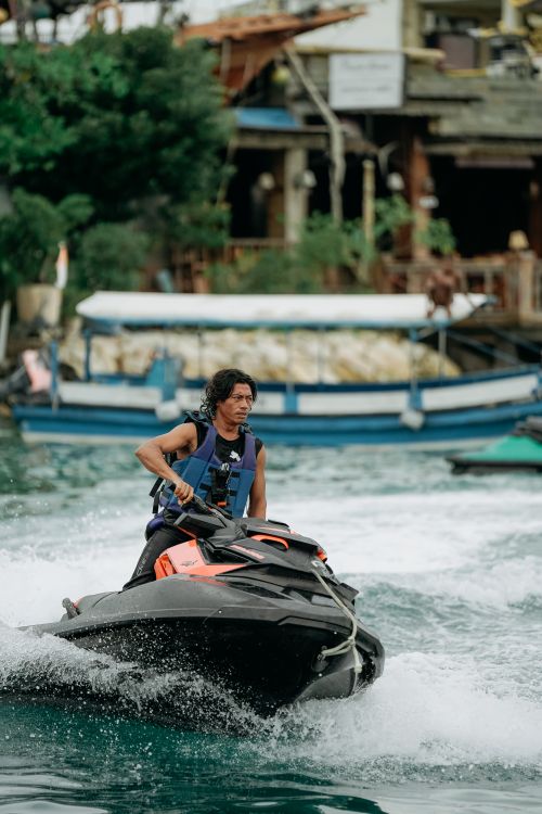 Free A man rides a jet ski on vibrant waters in Kuta Selatan, Bali, showcasing thrilling water sport action. Stock Photo