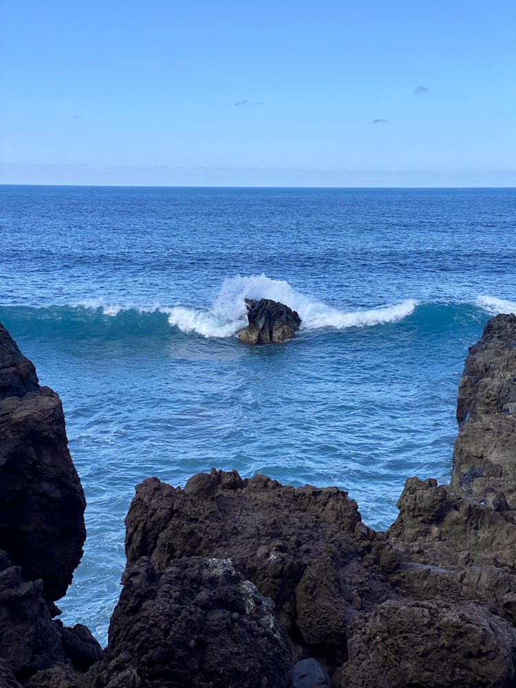 A Sea Wave Crashing On A Rock Formation