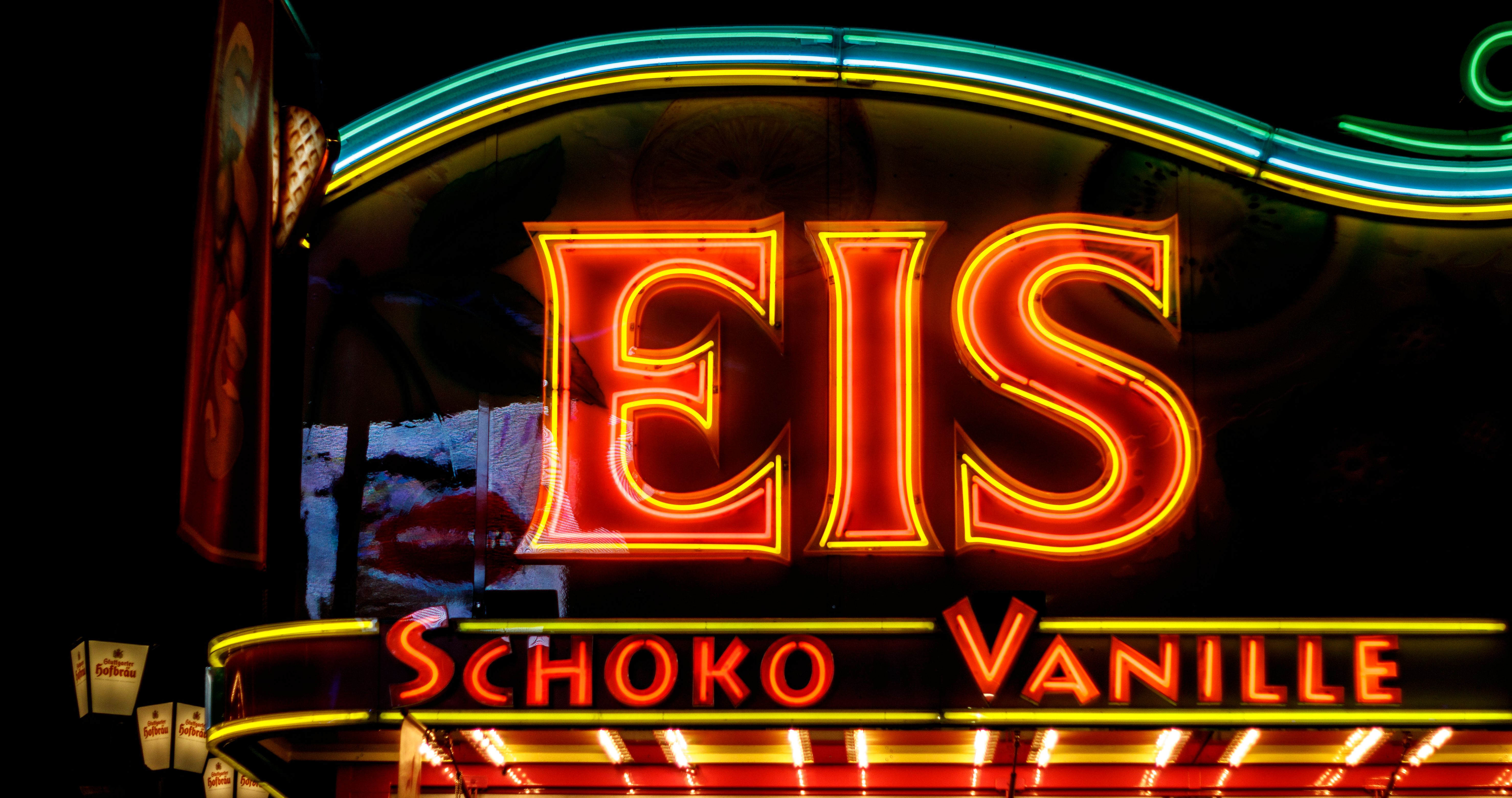 Illuminated neon sign promoting chocolate and vanilla ice cream variety.