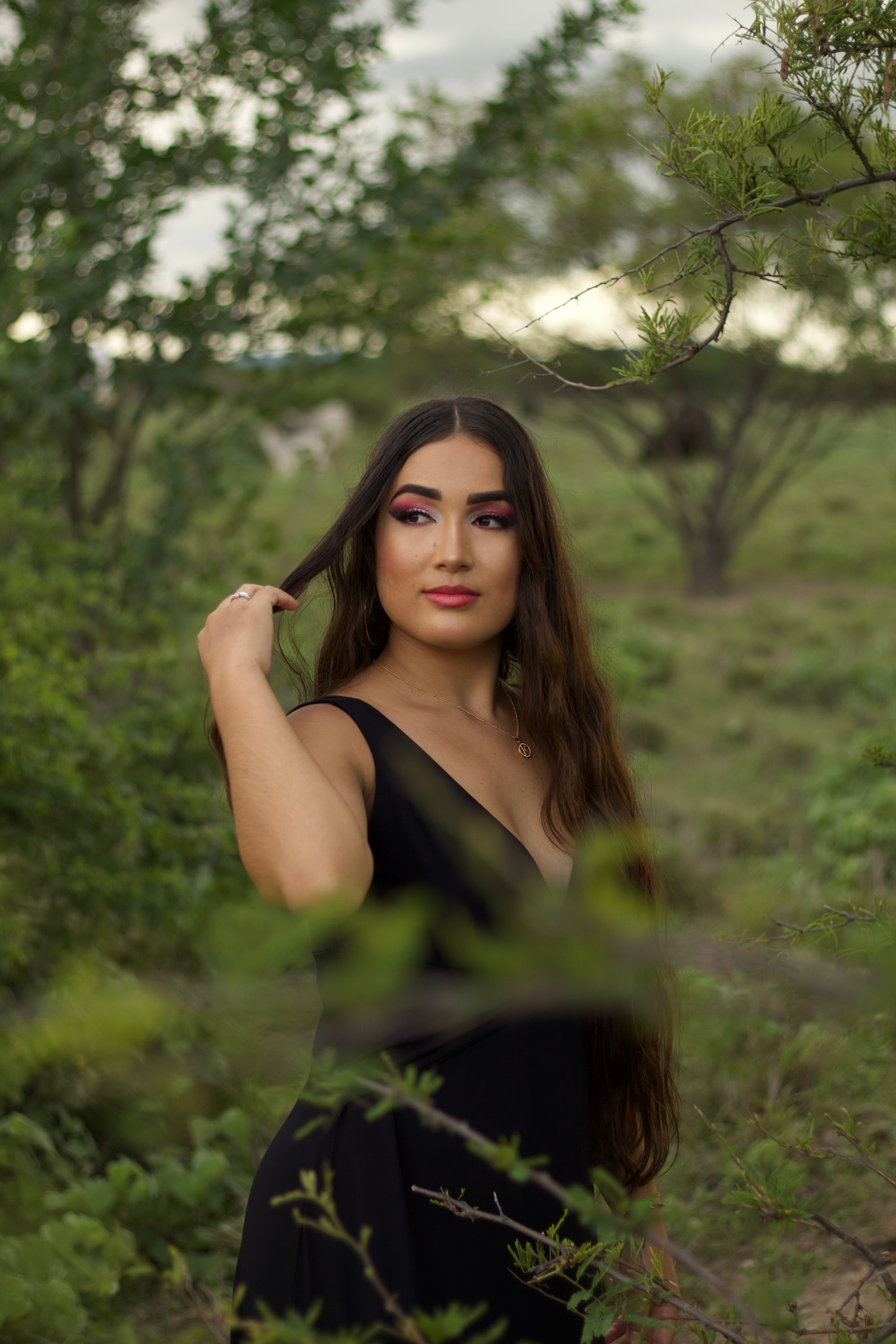 A Woman in Black Dress Standing near Plants · Free Stock Photo