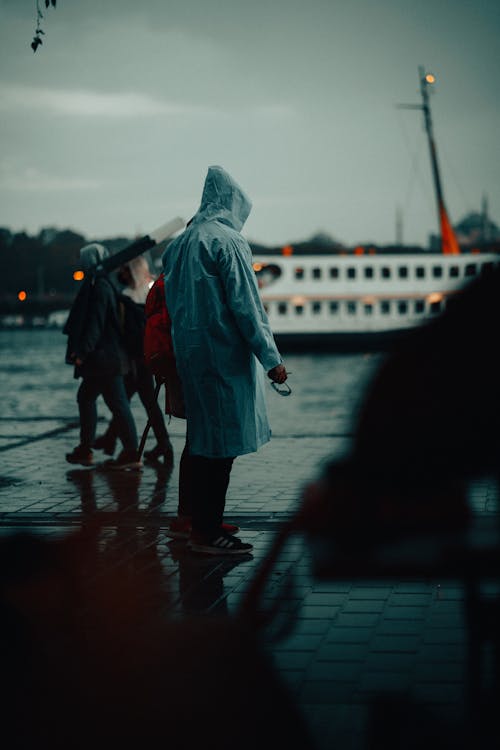 Man in Raincoat in Harbor