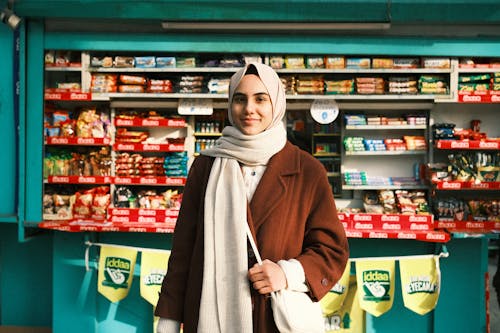 A Woman in Brown Coat Wearing Headscarf