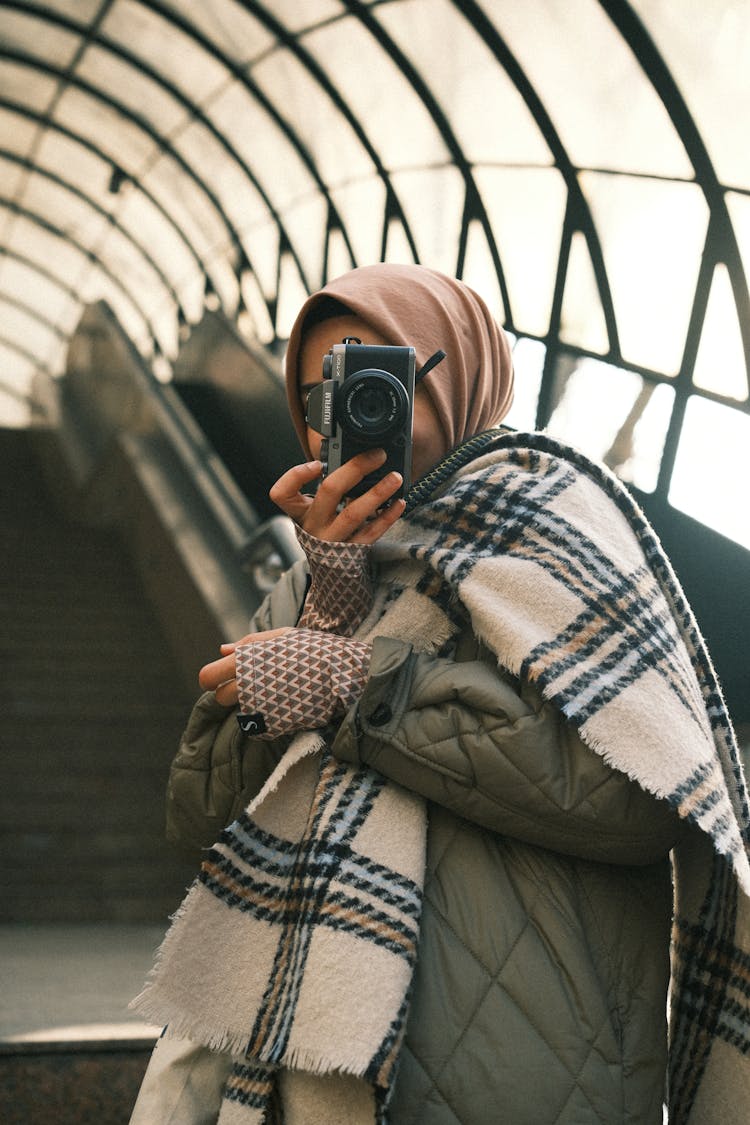 Photo Of A Person In A Checked Scarf Taking A Photo On Stairs