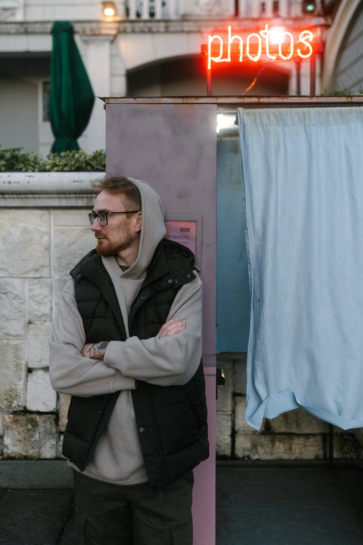 Stylish Young Man Standing Near Photo Booth Outdoors