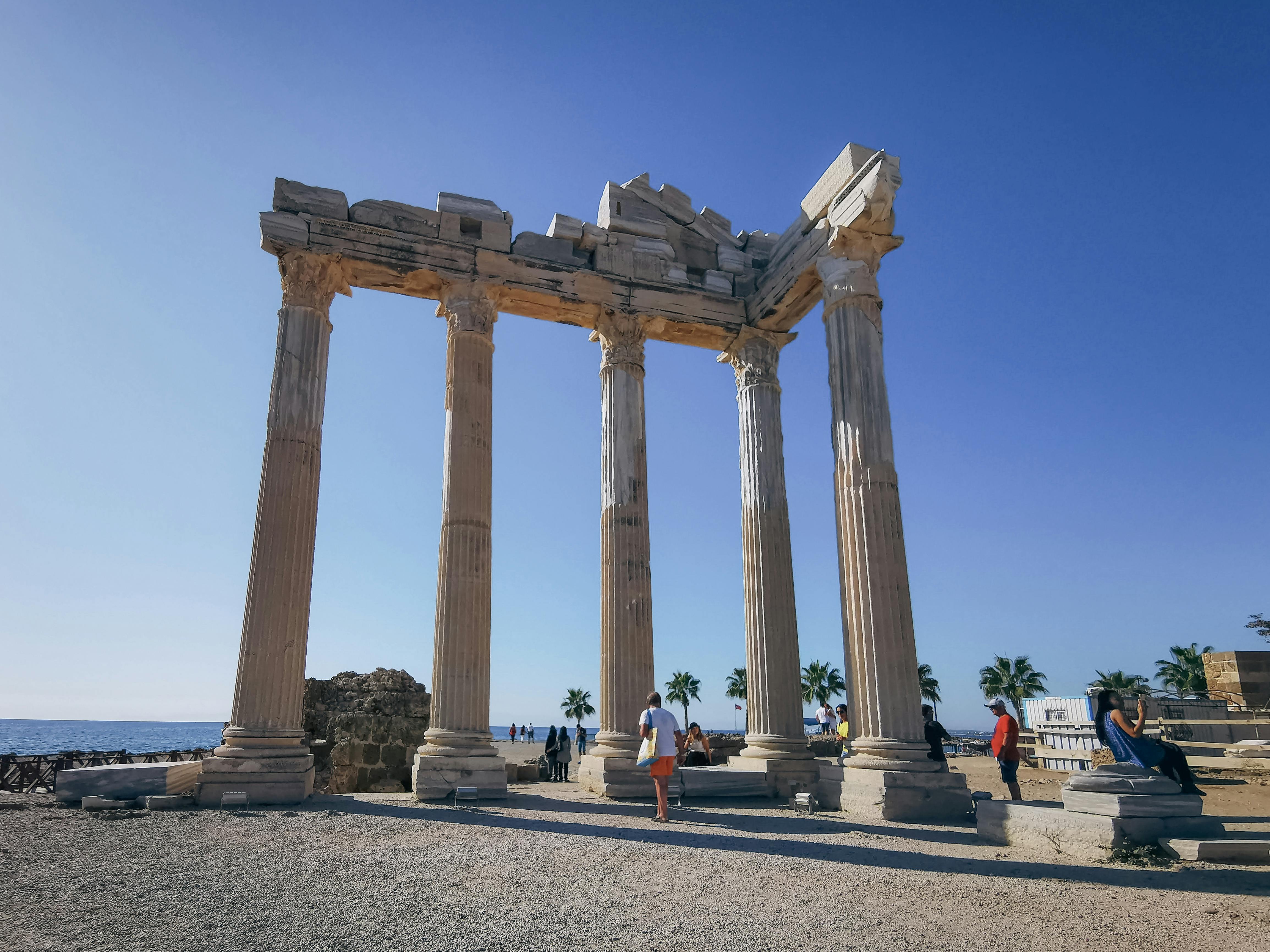 Side Temple of Apollo Turkey with ancient Corinthian columns silhouetted against Mediterranean sunset and turquoise waters