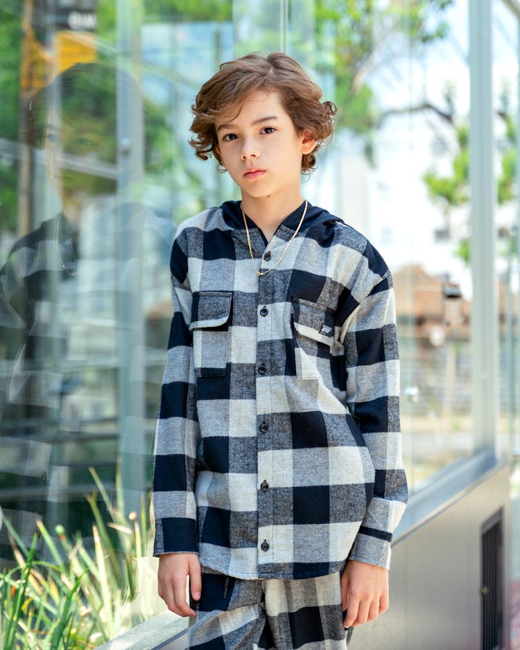 Boy In Checkered Suit Posing Outdoors