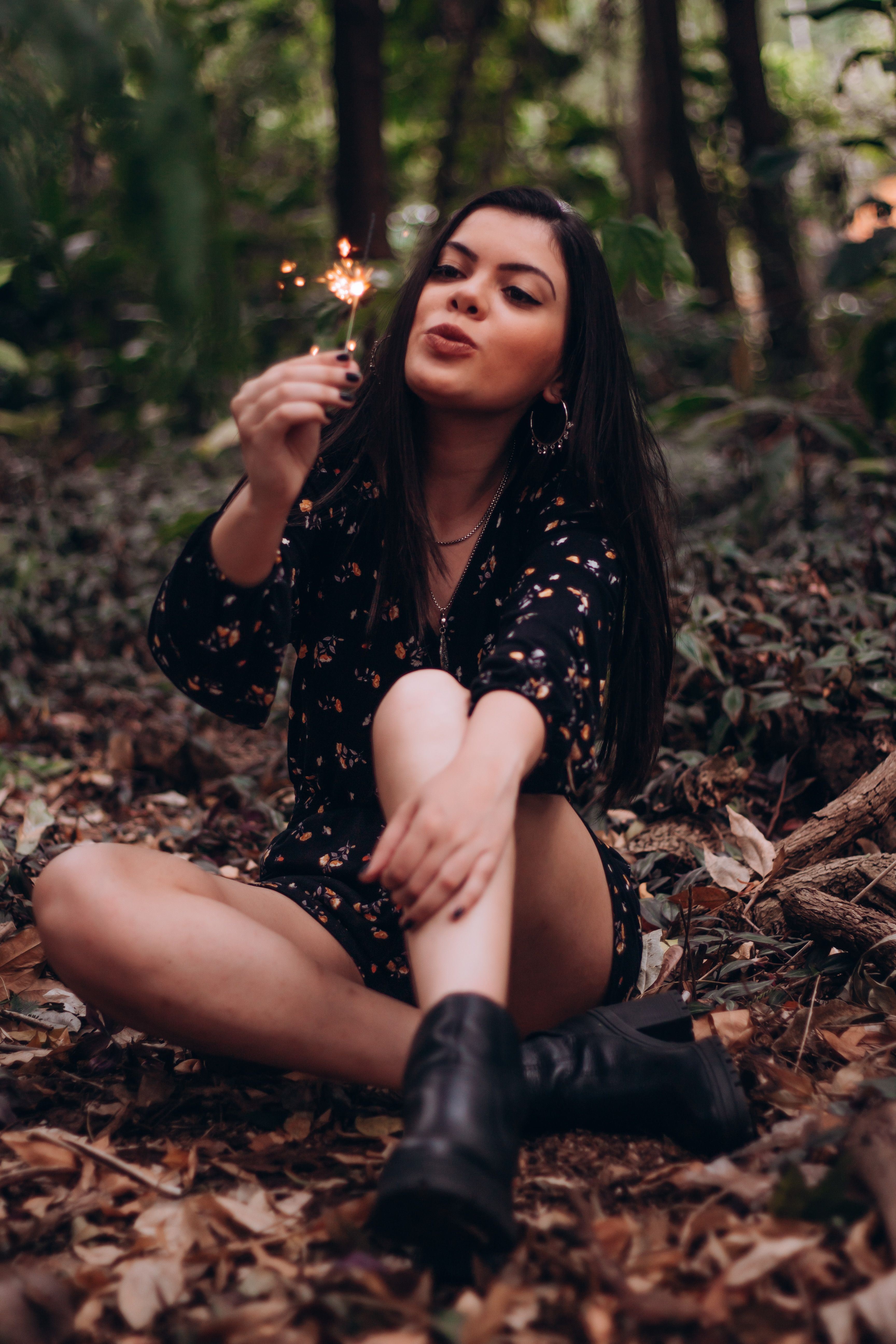 Woman Sitting on the Ground While Holding a Sparkler · Free Stock Photo