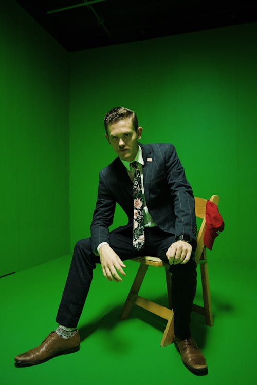 Man Wearing Suit Sitting on a Chair