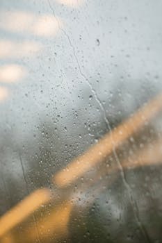 A detailed view of raindrops on a window, capturing nature's serene beauty in Bonn, Germany.