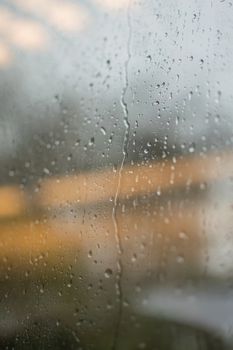 Close-up of raindrops on a glass window, capturing rainy atmosphere in Bonn, Germany.