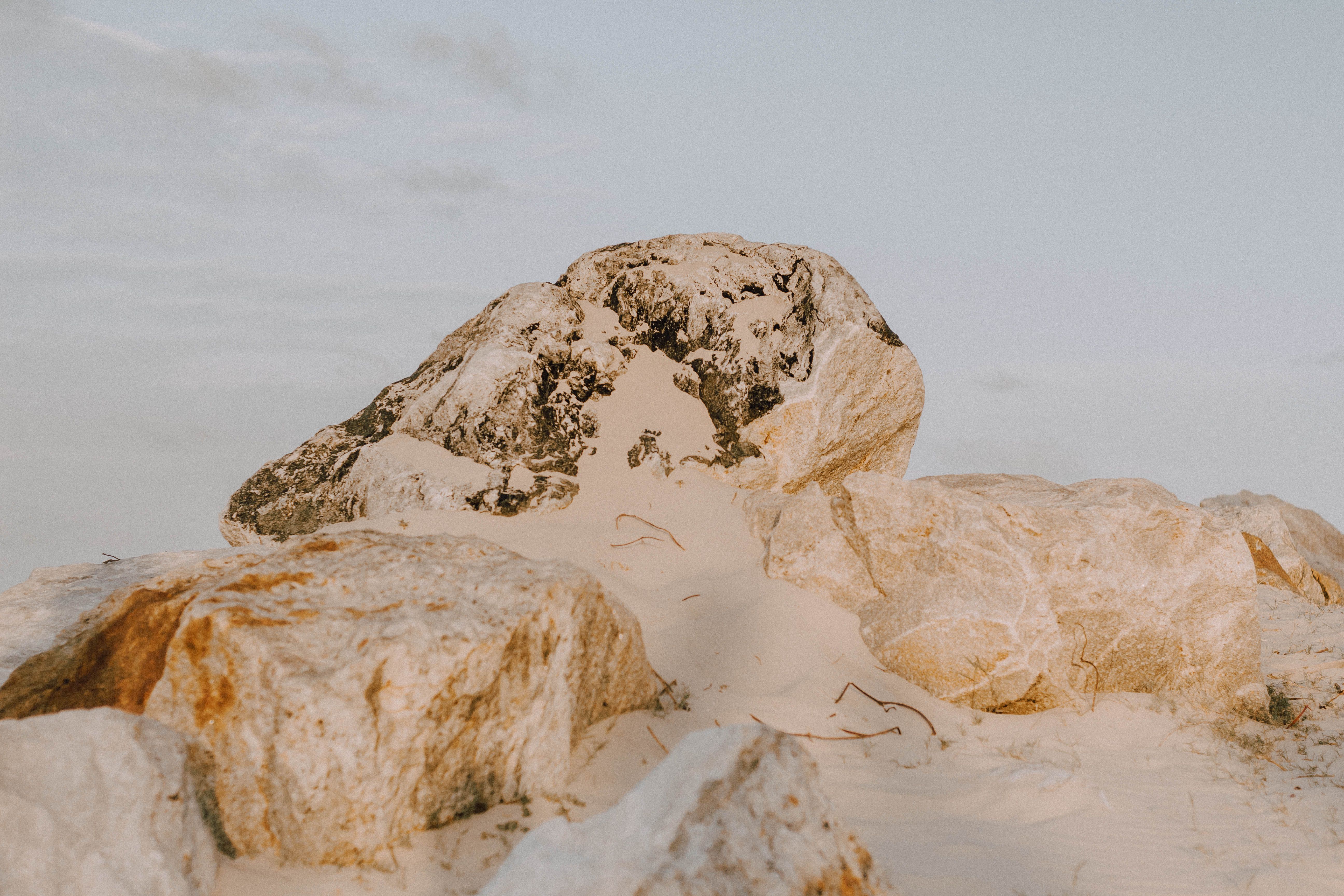 Serene desert landscape with rocky formations and white sand in Parajuru, Brazil.