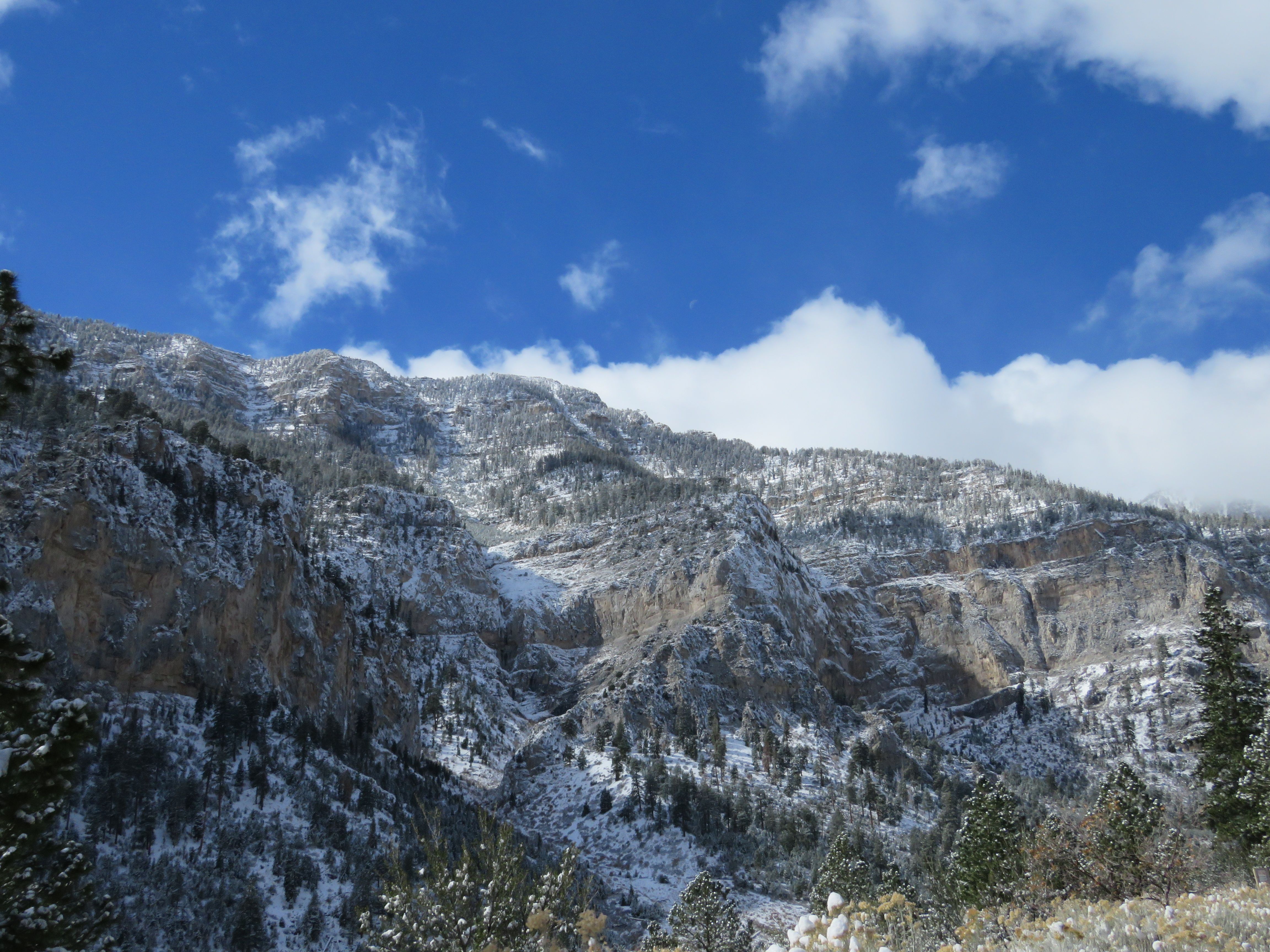 Aerial Photography of a Rocky Mountain covered in Snow · Free Stock Photo