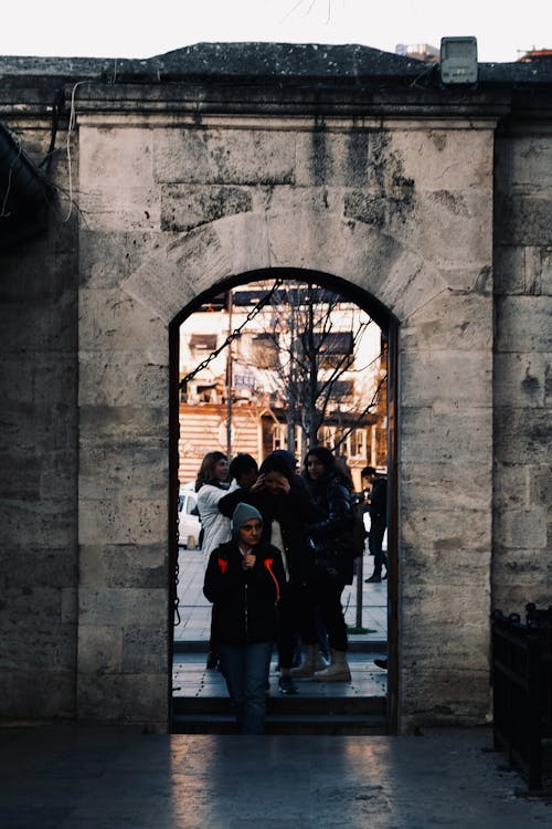 People Standing by the Doorway