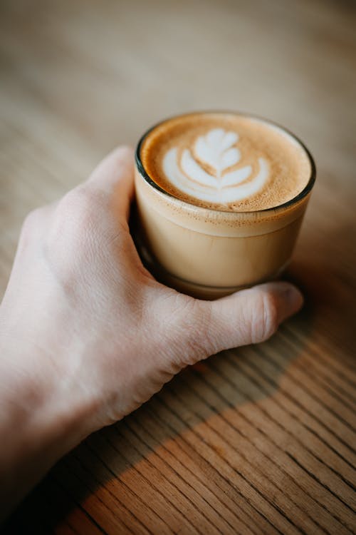 Free Photo of a Glass of Coffee Held in a Hand Stock Photo