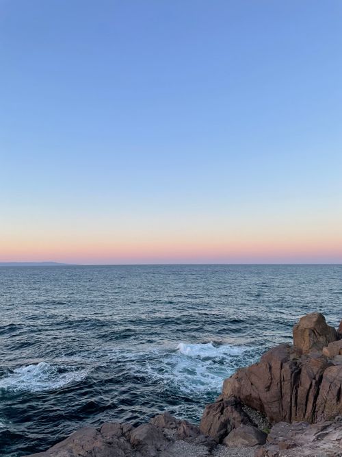 Free Peaceful seascape at sunset in Sozopol, Bulgaria, showcasing rocks and serene waves. Stock Photo
