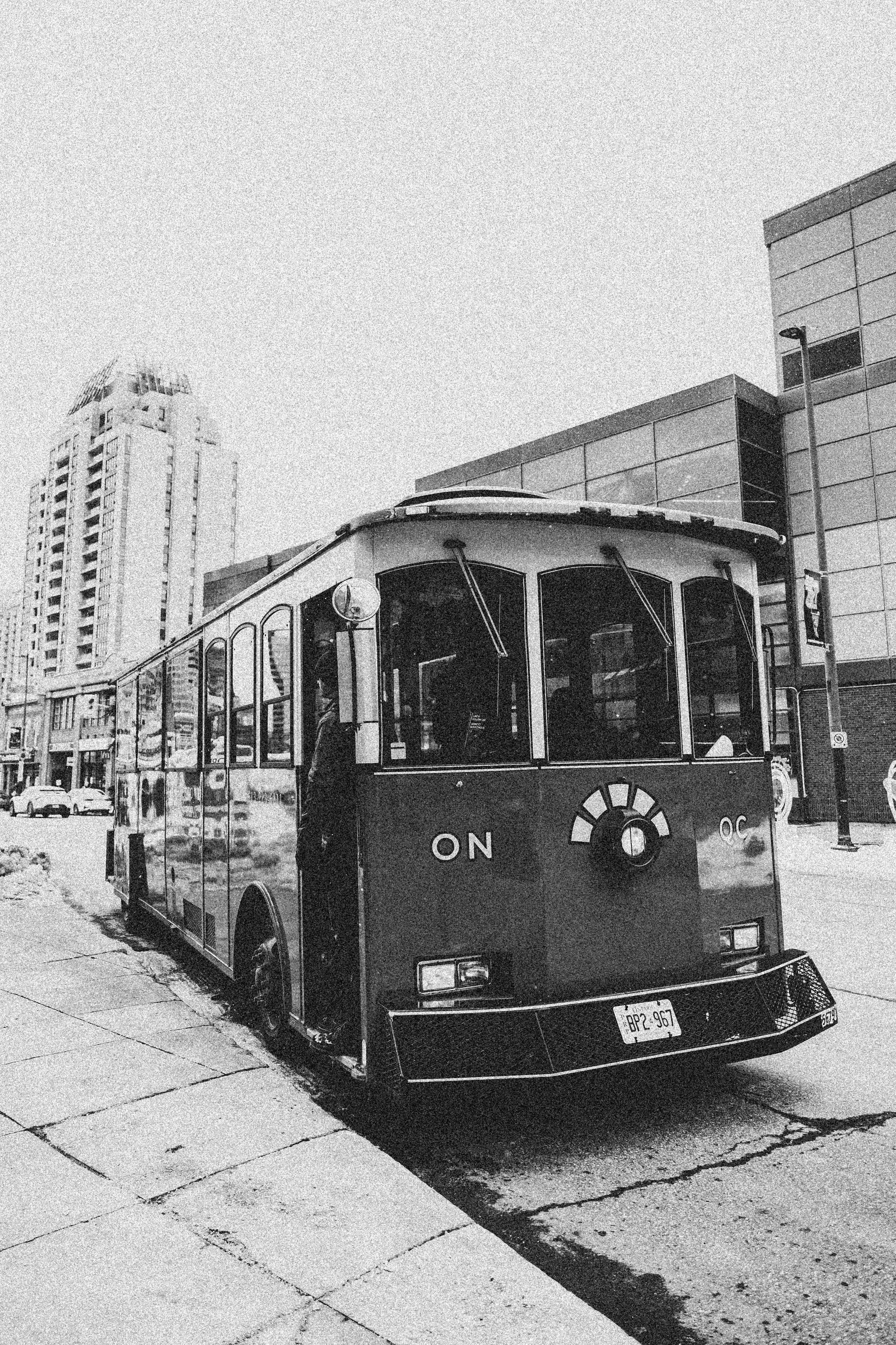 A nostalgic black and white image of a streetcar on a city street enhances urban charm.