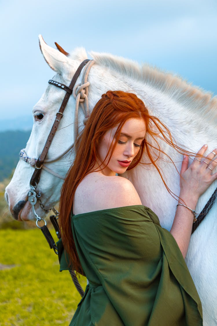 Redhead Woman Posing Near White Horse In Nature