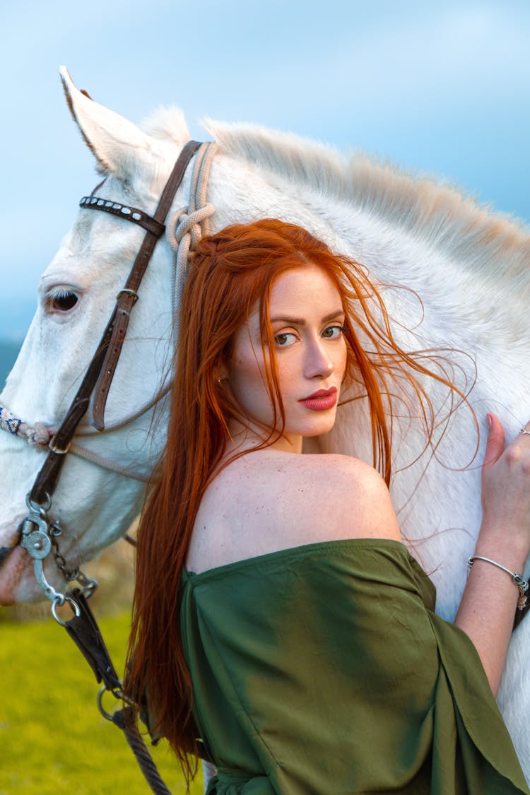 Redhead Woman Near White Horse In Nature