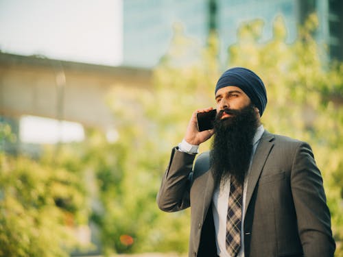 Free Man with Beard Talking on the Phone Stock Photo