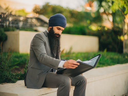 Man with a Beard Reading Documents