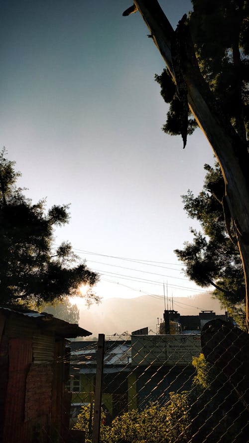 Silhouette of Mountain Seen from Village at Dawn