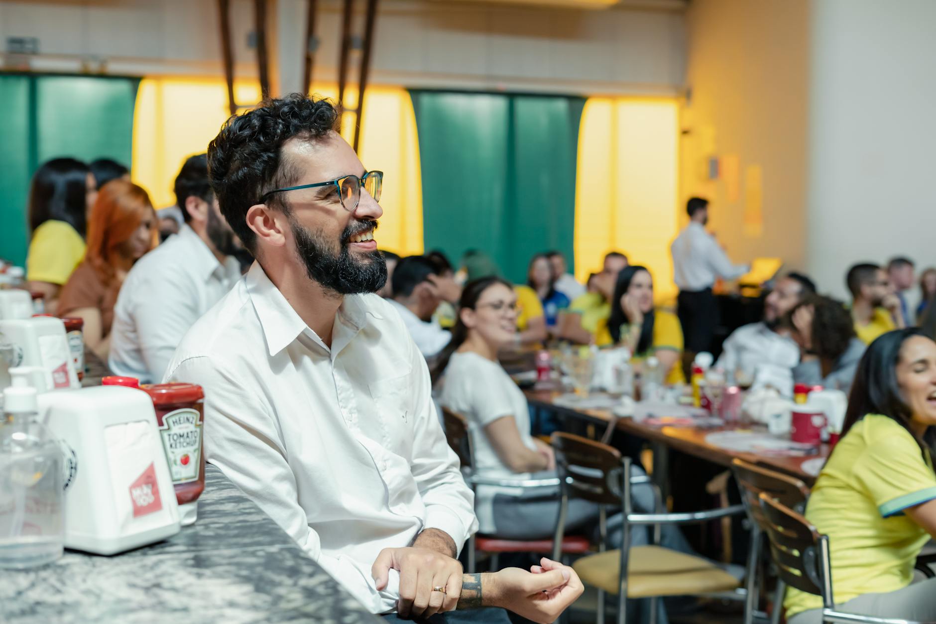 People Socializing At A Party, Smiling And Engaging In Conversation